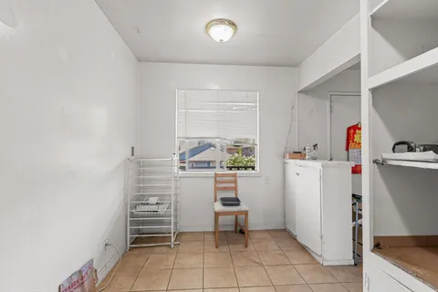 a kitchen with a refrigerator and white cabinets