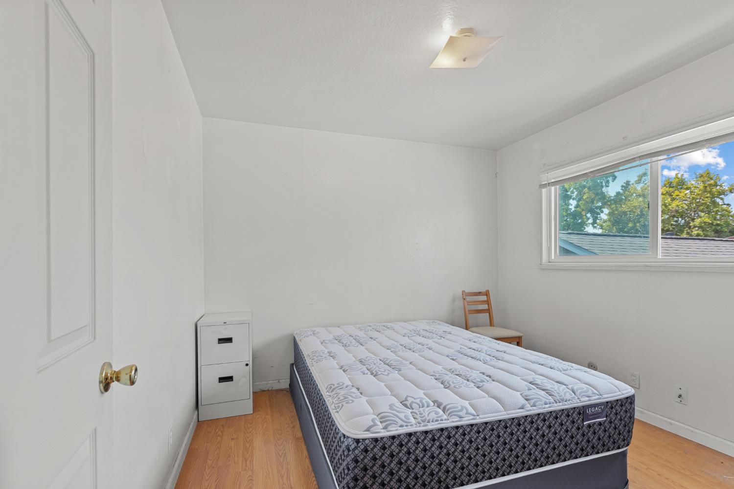 2123 15th Avenue Sacramento, CA 95822 - Photo 10 of 35 a bedroom with a bed and wooden floor