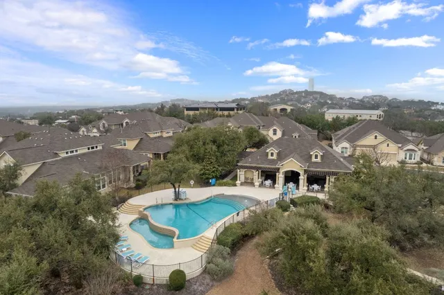 a view of a city with lawn chairs and large tree