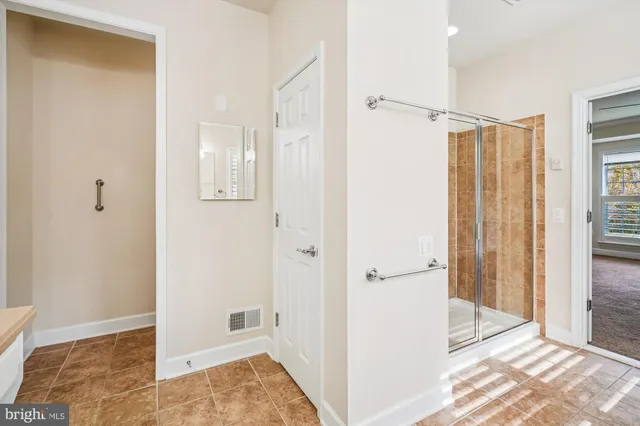 a bathroom with a shower and a tub