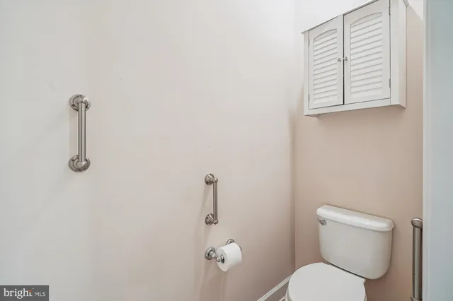 a white toilet sitting next to a shower