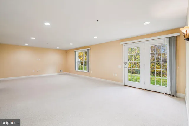 an empty room with a ceiling fan and a window