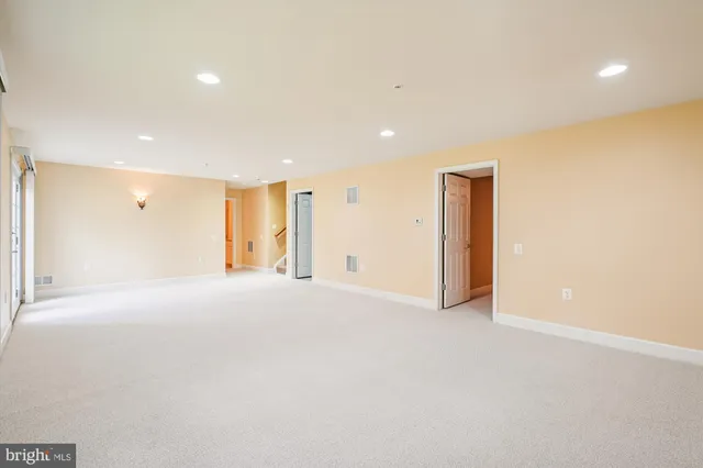 a view of an empty room with a ceiling fan
