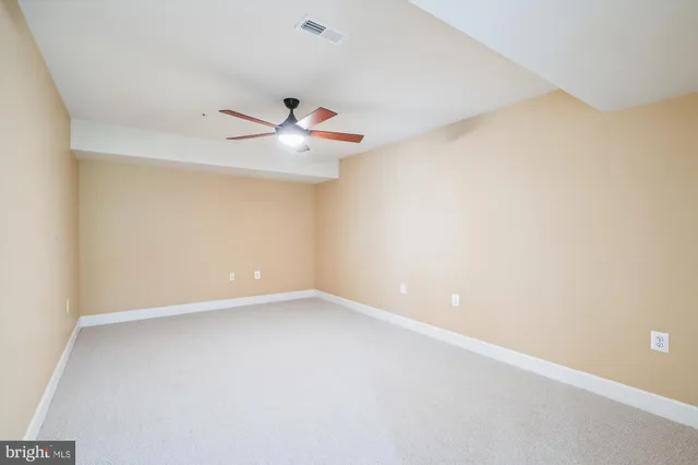 a view of a livingroom with a ceiling fan and window