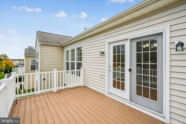 a view of balcony with wooden floor and fence