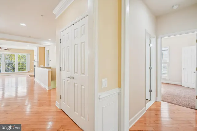 a view of a hallway with wooden floor and entryway
