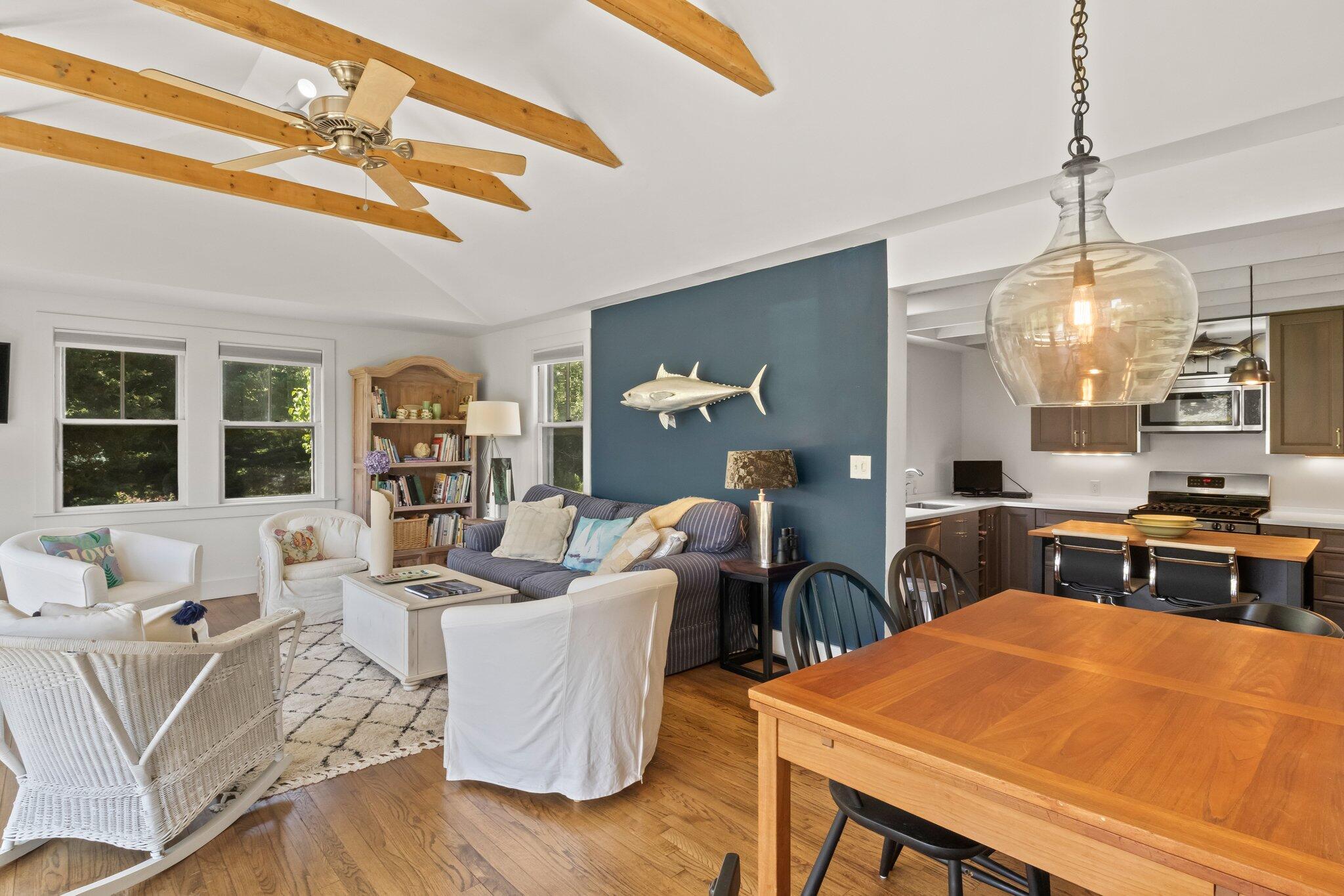 4 Pond Road, Unit B Truro, MA 02666 - Photo 16 of 40 a living room with furniture and a chandelier