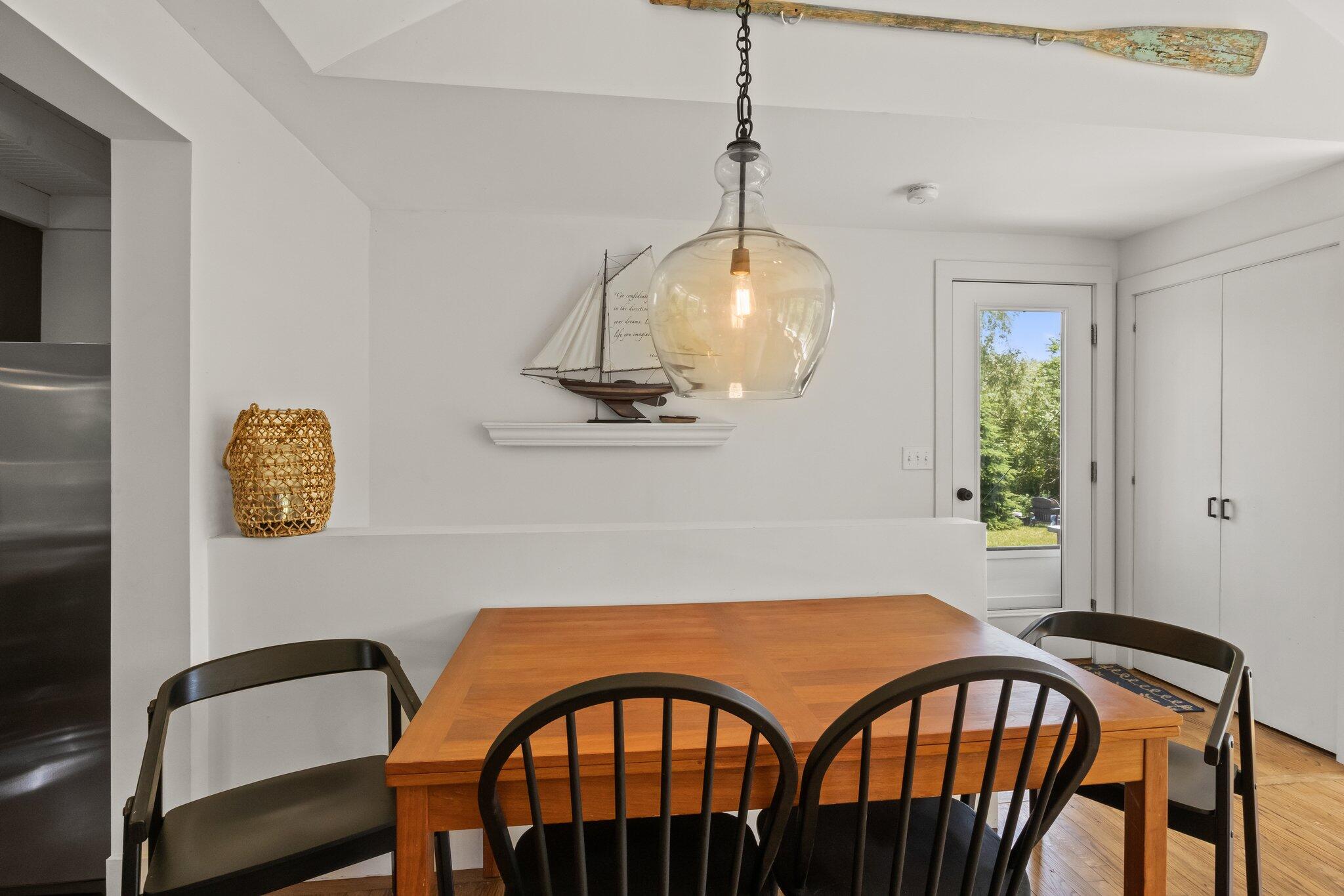 4 Pond Road, Unit B Truro, MA 02666 - Photo 18 of 40 a view of a dining room with furniture and chandelier