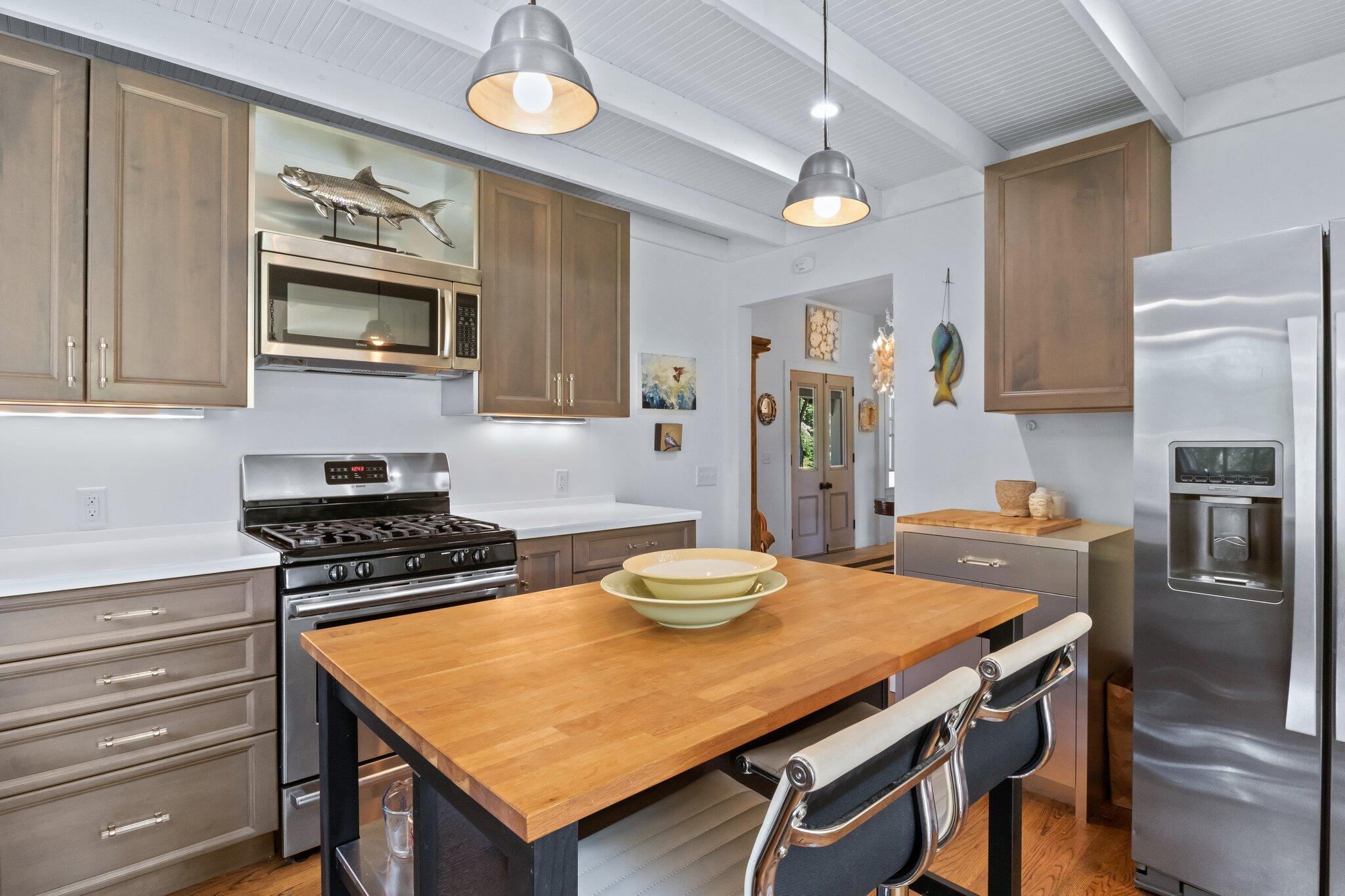 4 Pond Road, Unit B Truro, MA 02666 - Photo 21 of 40 a kitchen with a table chairs stove and microwave