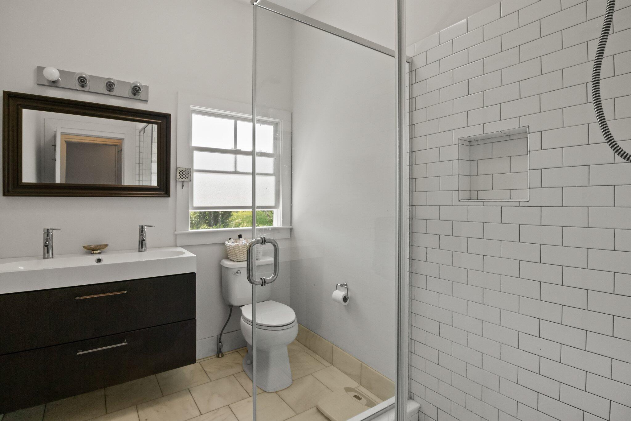 4 Pond Road, Unit B Truro, MA 02666 - Photo 26 of 40 a bathroom with a toilet sink vanity and mirror