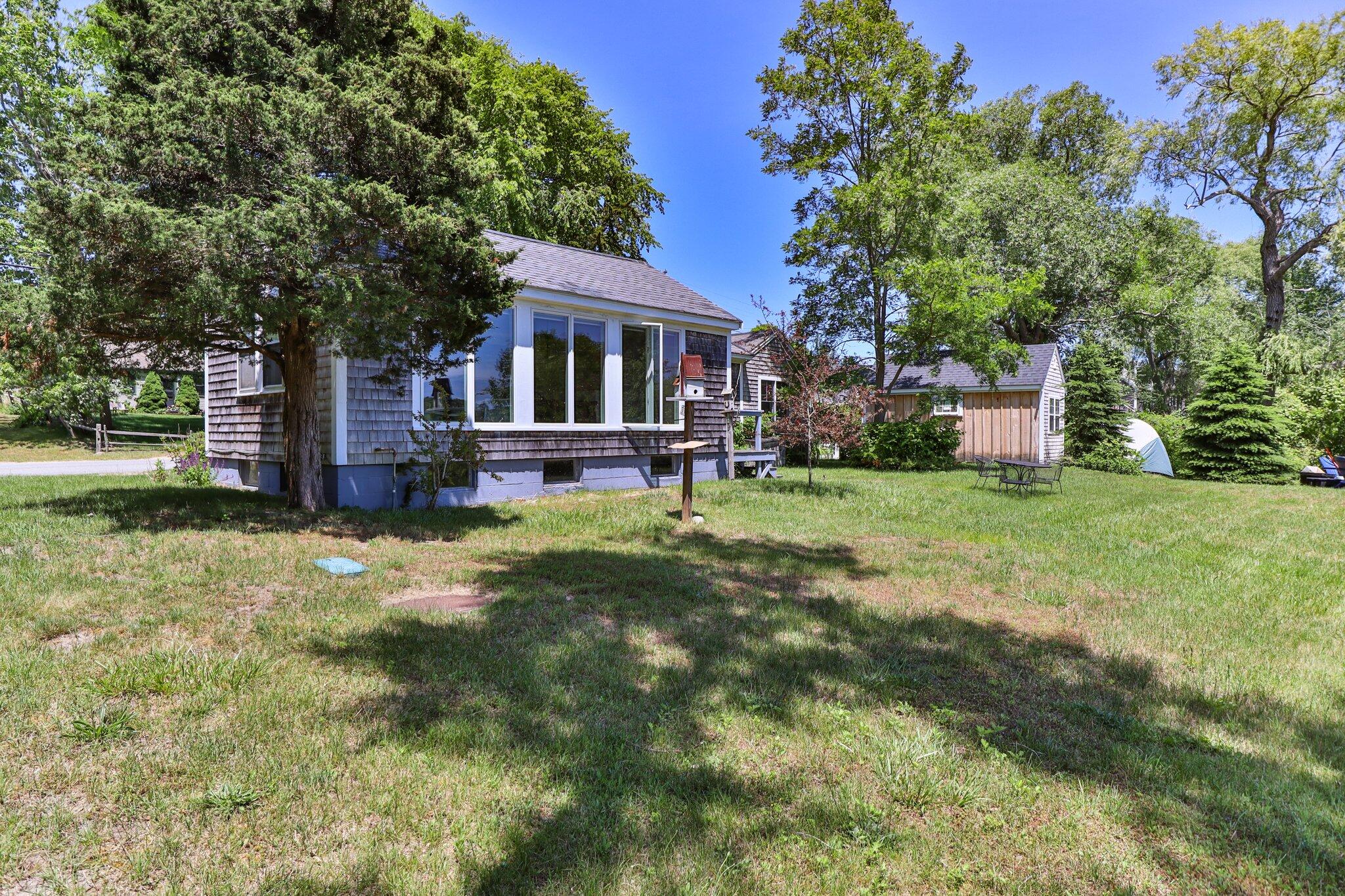 4 Pond Road, Unit B Truro, MA 02666 - Photo 28 of 40 a front view of a house with a yard