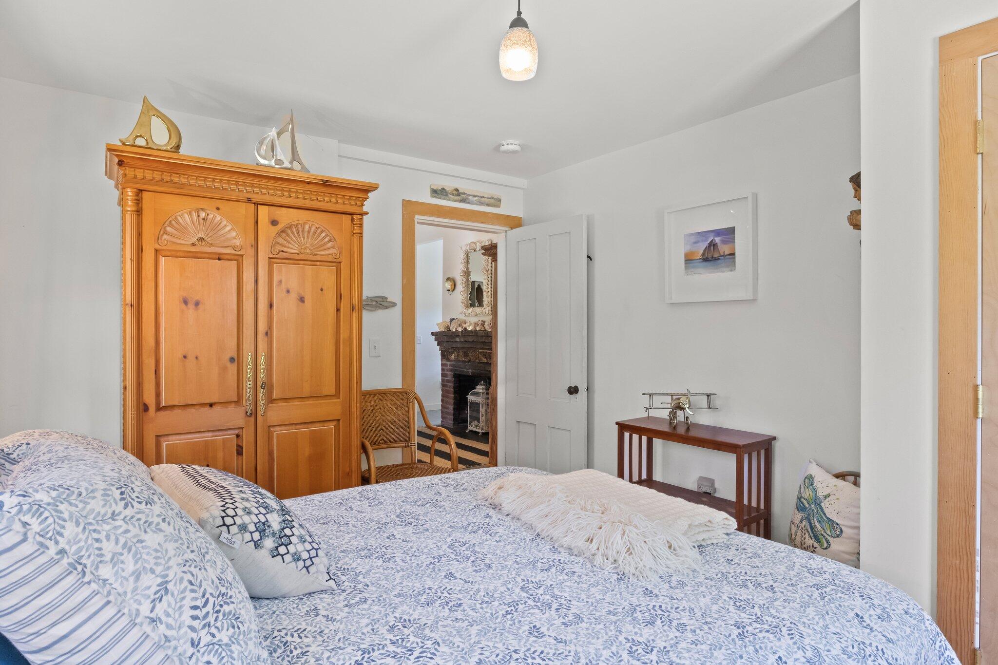4 Pond Road, Unit B Truro, MA 02666 - Photo 29 of 40 a bedroom with a bed and a dresser in it