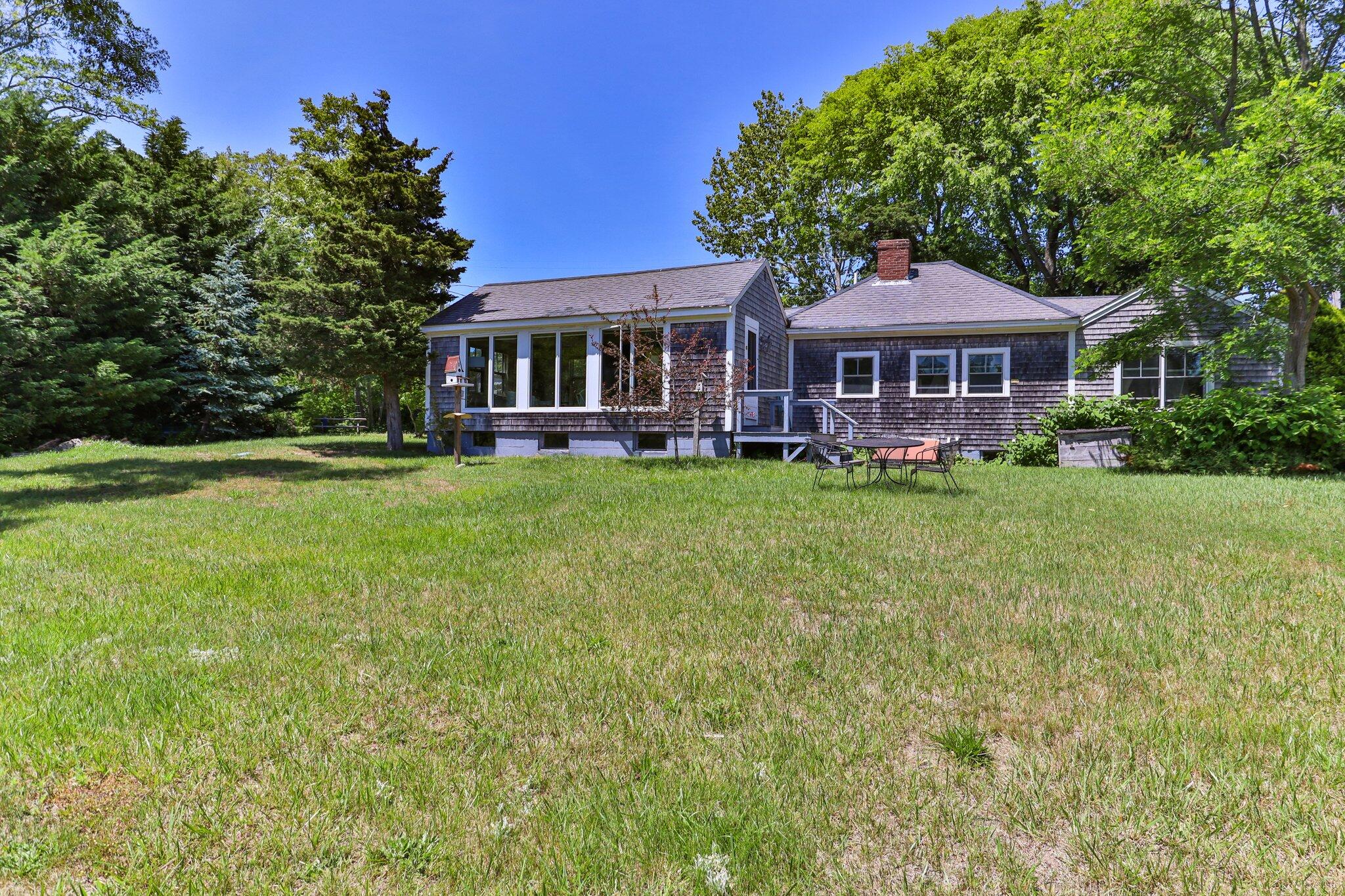 4 Pond Road, Unit B Truro, MA 02666 - Photo 31 of 40 a front view of a house with a garden
