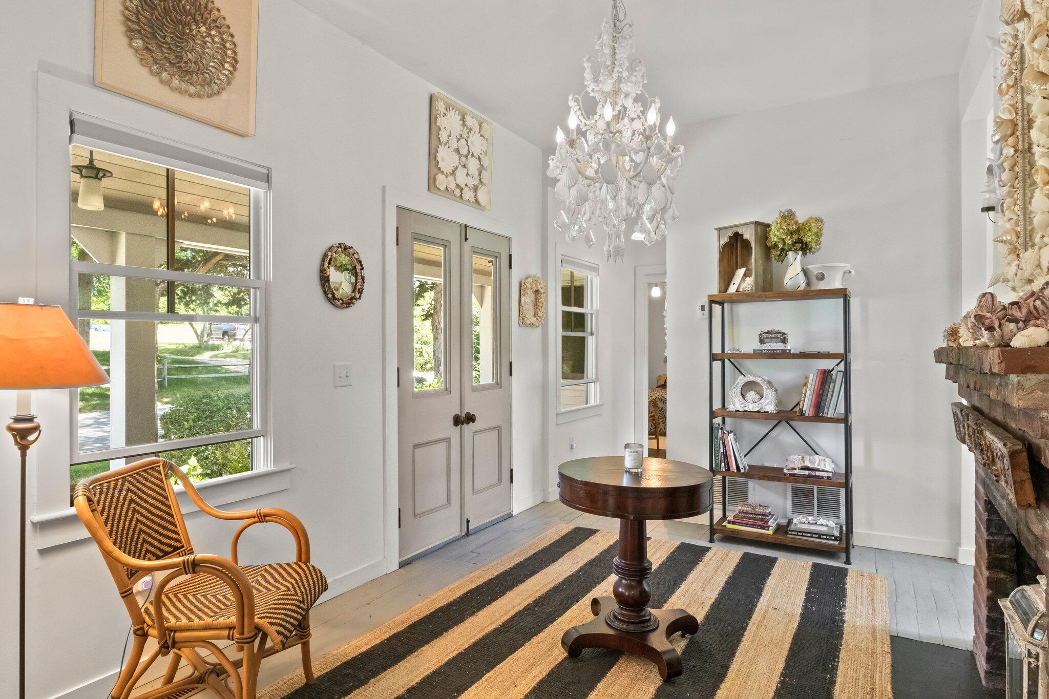 4 Pond Road, Unit B Truro, MA 02666 - Photo 8 of 40 a living room with furniture and a chandelier