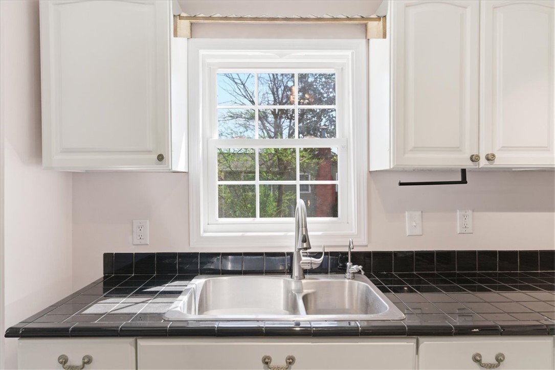 112 Newry Road Seneca, SC 29672 - Photo 6 of 19 This kitchen features a window overlooking lush greenery, complemented by a dual basin sink.