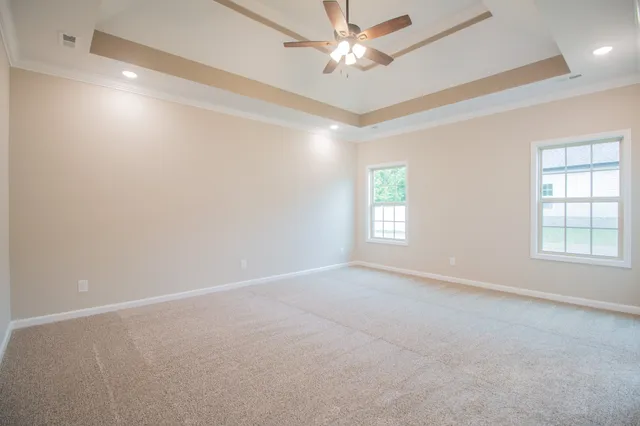 an empty room with a window and a fan