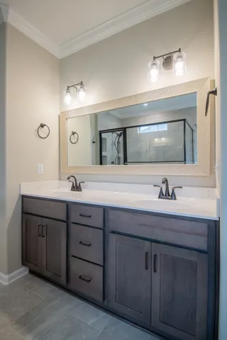 a bathroom with a granite countertop sink double and mirror