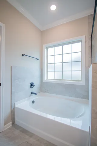 a white bath tub sitting next to a window