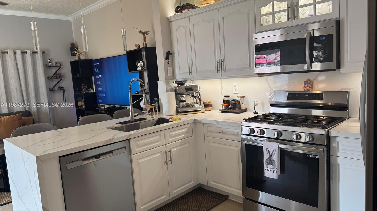 4220 Southwest 153rd Avenue Miramar, FL 33027 - Photo 11 of 34 a kitchen with stainless steel appliances granite countertop a stove a refrigerator and a microwave