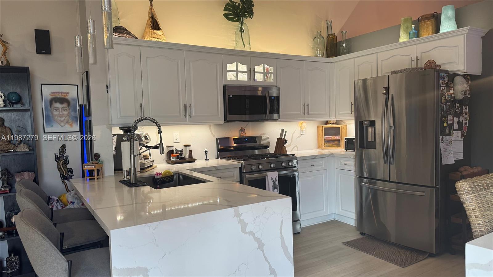 4220 Southwest 153rd Avenue Miramar, FL 33027 - Photo 12 of 34 a kitchen with a refrigerator and a stove top oven