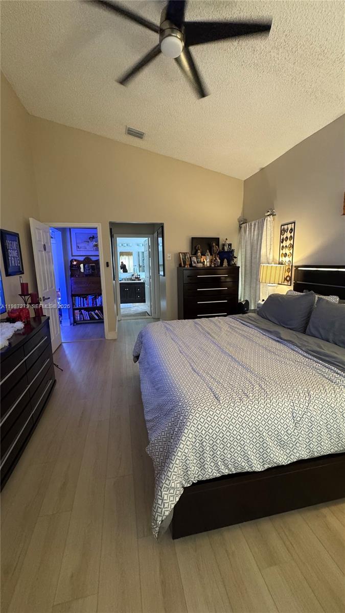 4220 Southwest 153rd Avenue Miramar, FL 33027 - Photo 16 of 34 a spacious bedroom with a bed and a tv