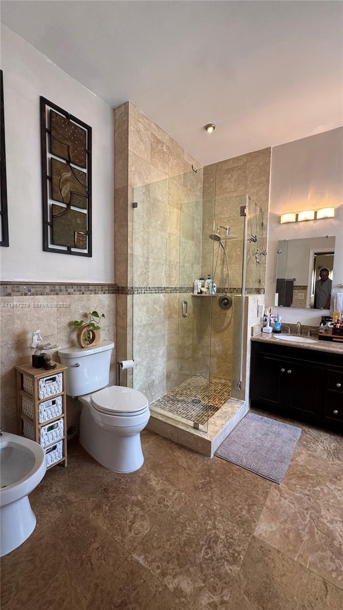 4220 Southwest 153rd Avenue Miramar, FL 33027 - Photo 18 of 34 a bathroom with a double vanity sink toilet and a mirror