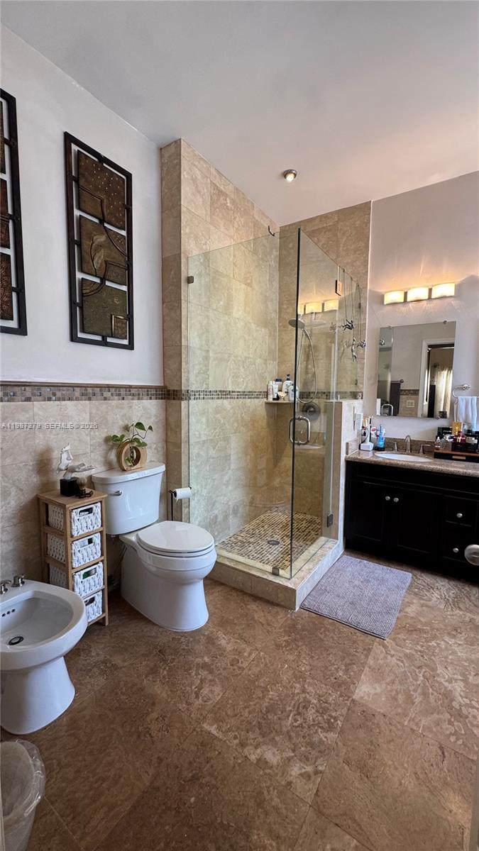4220 Southwest 153rd Avenue Miramar, FL 33027 - Photo 19 of 34 a bathroom with a double vanity sink toilet and mirror