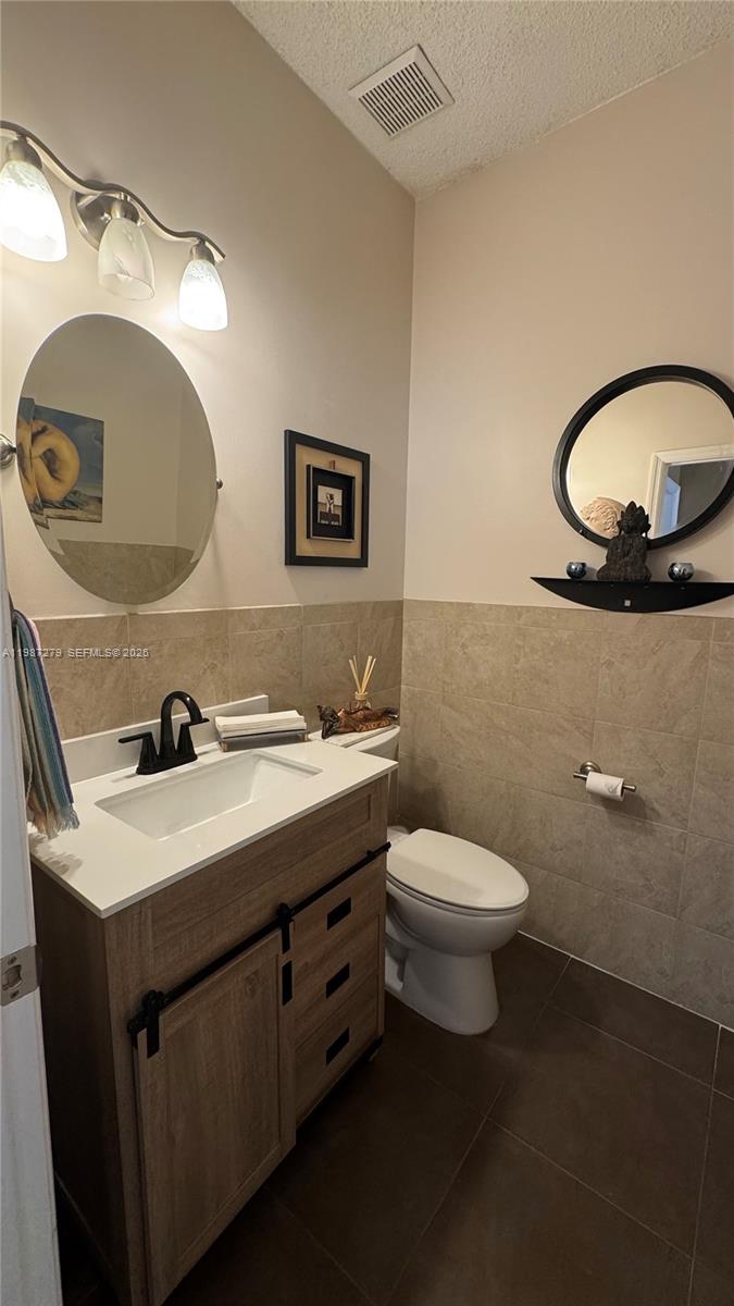 4220 Southwest 153rd Avenue Miramar, FL 33027 - Photo 21 of 34 a bathroom with a toilet a sink and a mirror