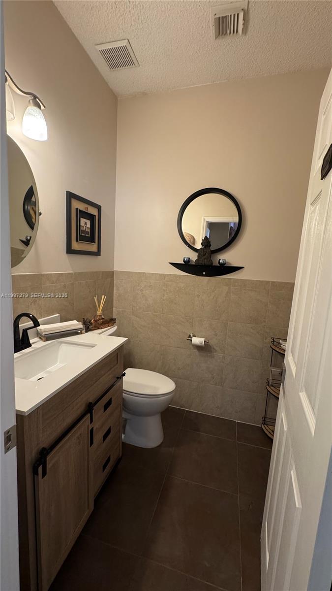 4220 Southwest 153rd Avenue Miramar, FL 33027 - Photo 22 of 34 a bathroom with a toilet sink and mirror