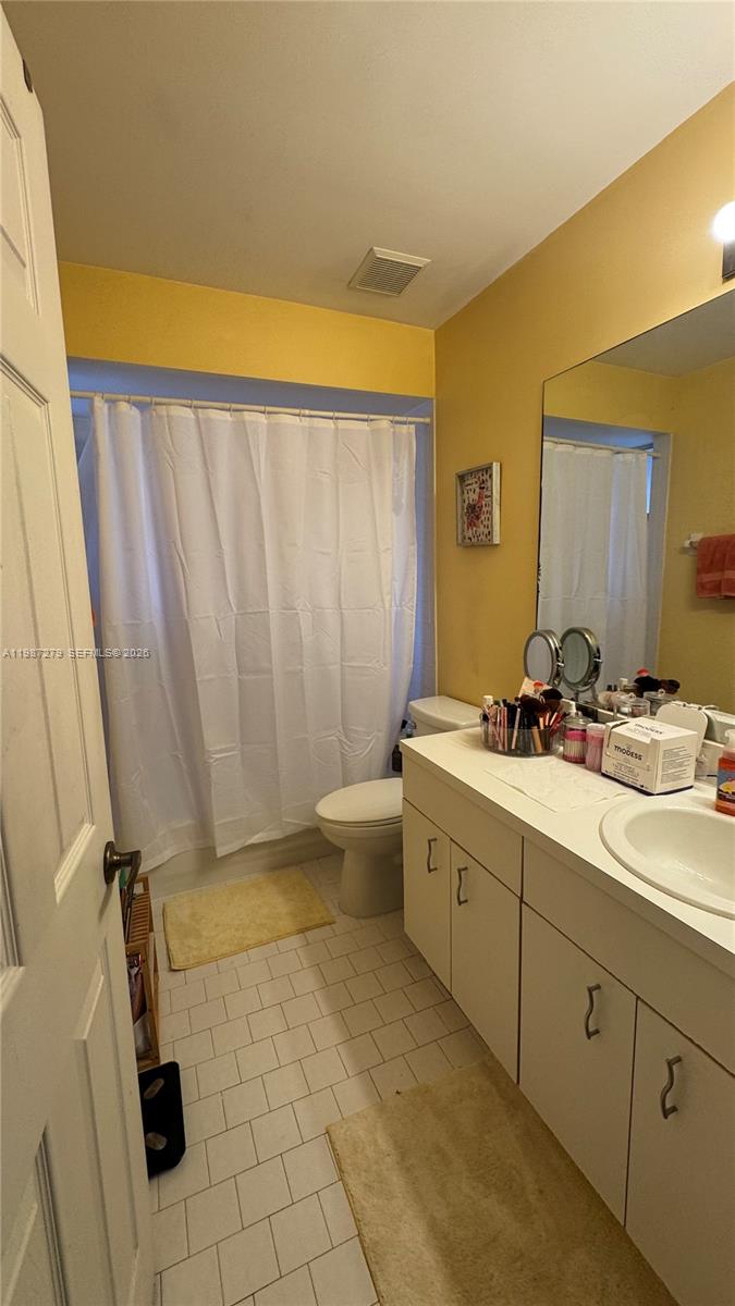4220 Southwest 153rd Avenue Miramar, FL 33027 - Photo 25 of 34 a bathroom with a double vanity sink toilet and shower