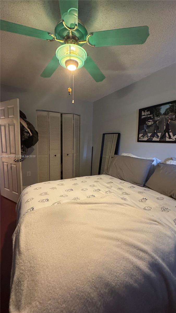 4220 Southwest 153rd Avenue Miramar, FL 33027 - Photo 27 of 34 a bed room with a bed mirror and a chandelier