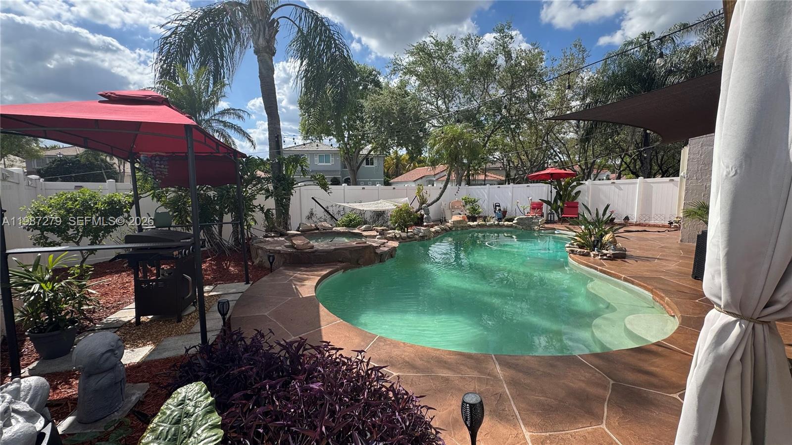 4220 Southwest 153rd Avenue Miramar, FL 33027 - Photo 30 of 34 an outdoor space with seating area and trees