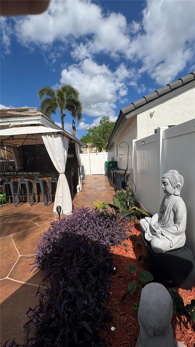 4220 Southwest 153rd Avenue Miramar, FL 33027 - Photo 33 of 34 a picture of a table and chairs in patio