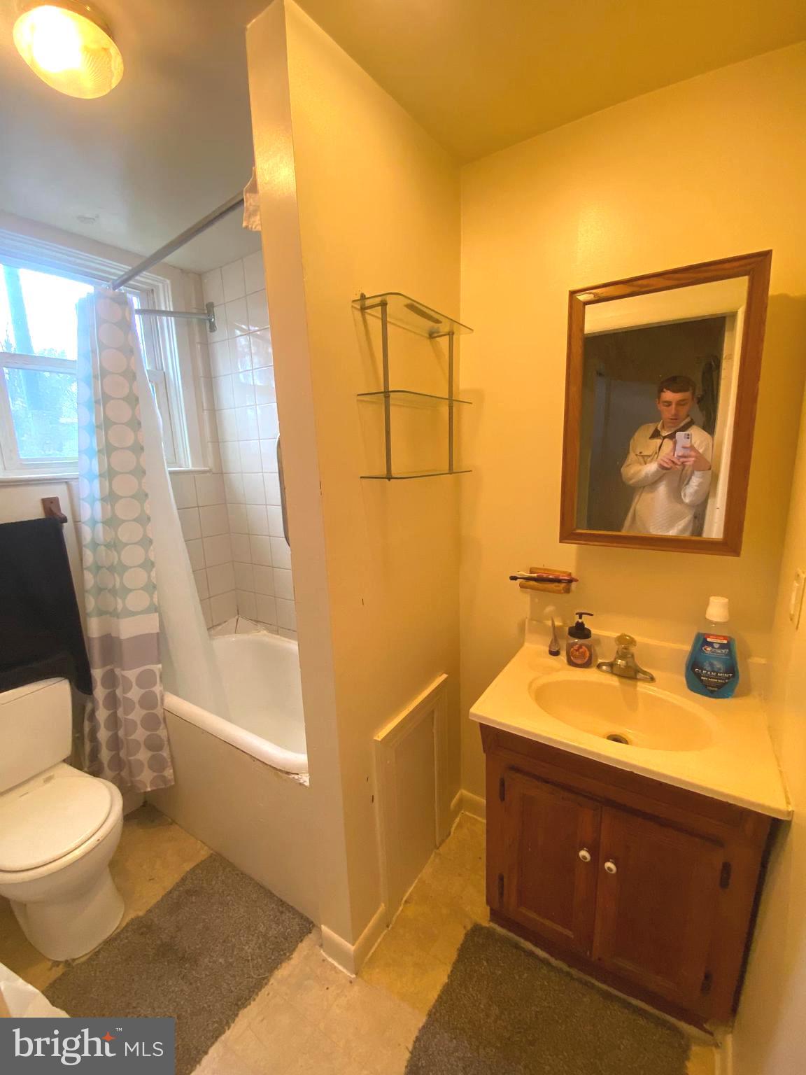 64 South Evans Street Pottstown, PA 19464 - Photo 11 of 31 a bathroom with a toilet sink and mirror