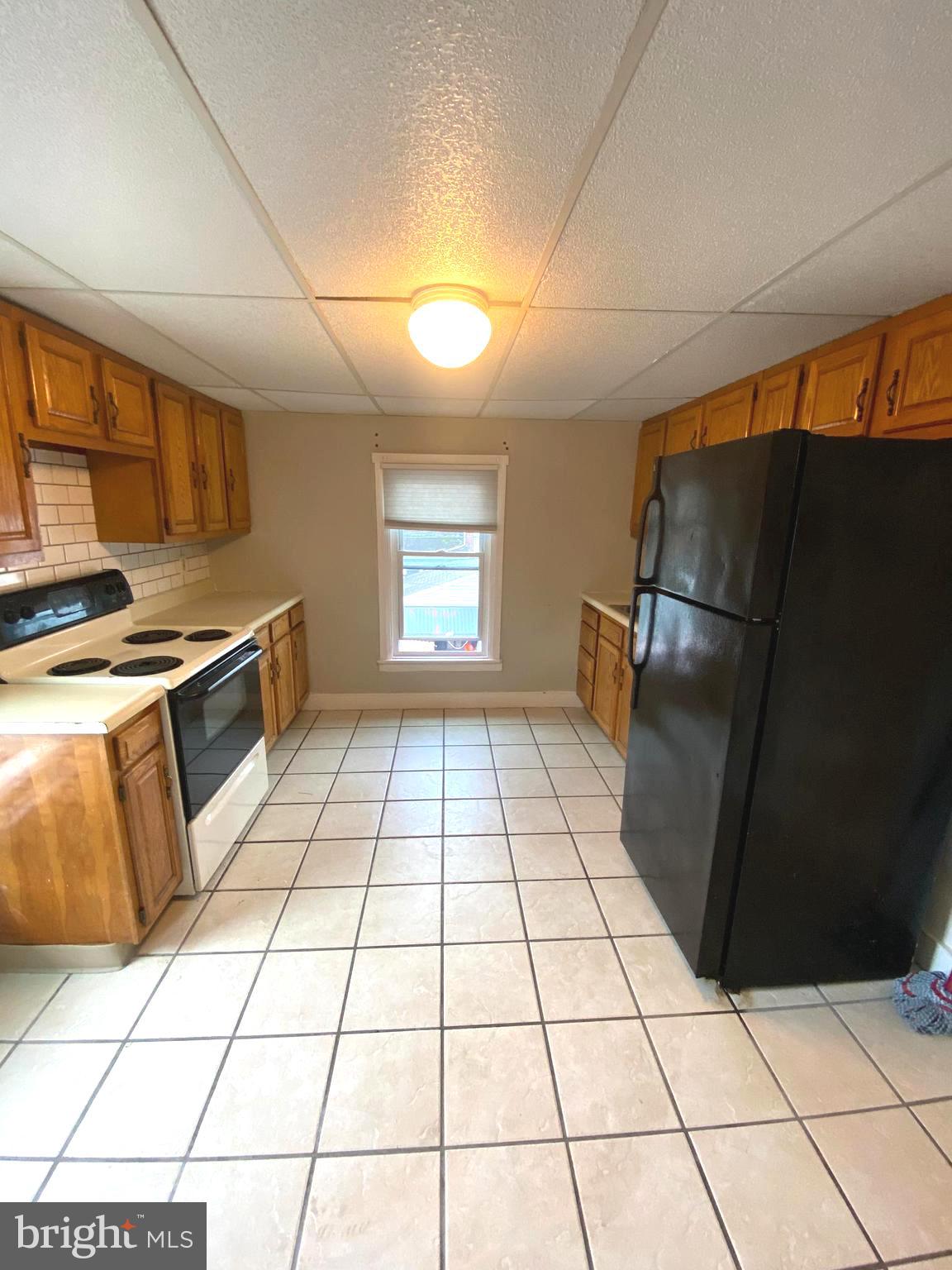 64 South Evans Street Pottstown, PA 19464 - Photo 15 of 31 a kitchen with granite countertop a stove a refrigerator a sink a counter top space and cabinets