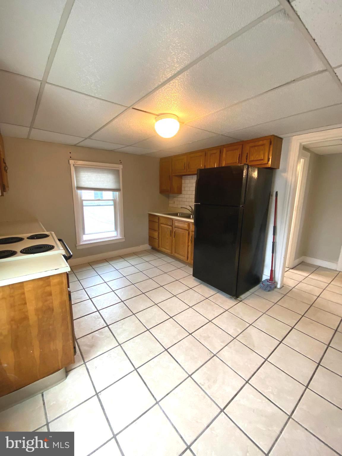 64 South Evans Street Pottstown, PA 19464 - Photo 16 of 31 a kitchen with a refrigerator and a stove