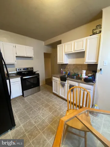 a kitchen with granite countertop a stove and a sink