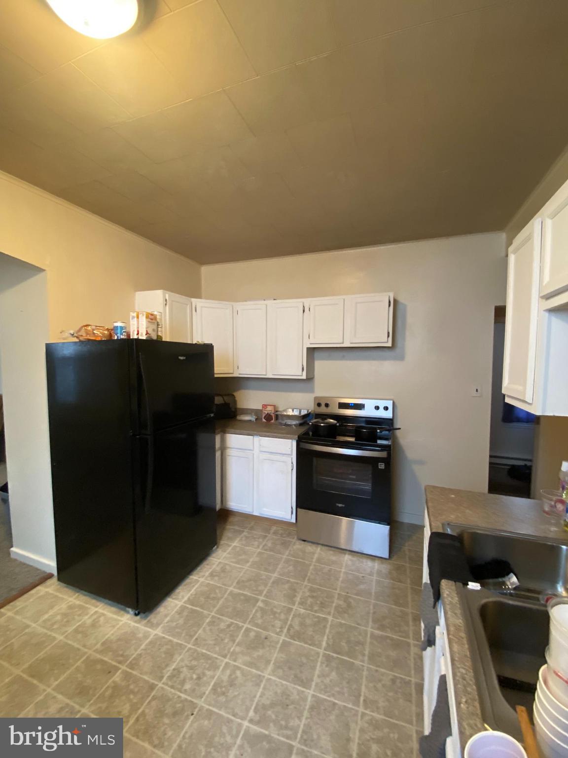 64 South Evans Street Pottstown, PA 19464 - Photo 9 of 31 a kitchen with a refrigerator and a stove