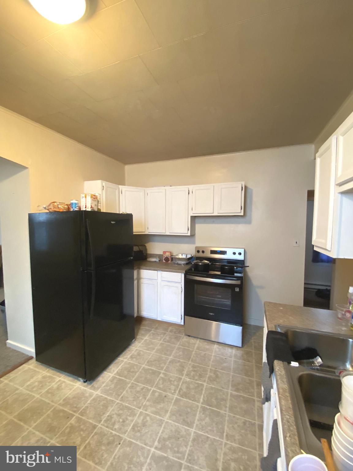 64 South Evans Street Pottstown, PA 19464 - Photo 9 of 31 a kitchen with stainless steel appliances granite countertop a refrigerator and a stove top oven