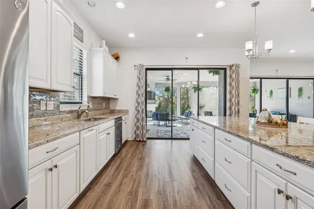a living room with furniture a flat screen tv and a floor to ceiling window