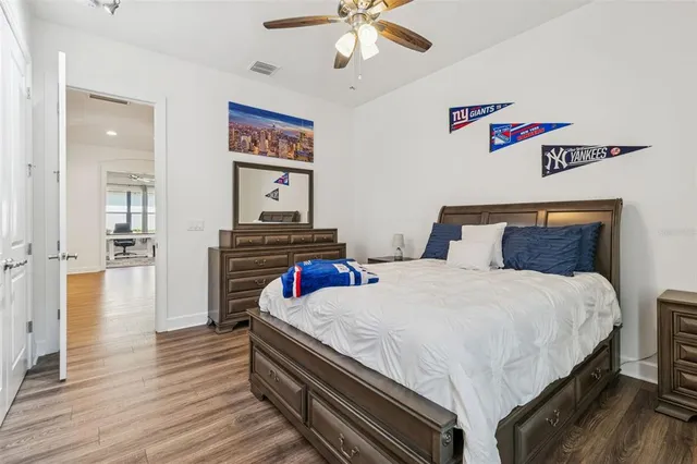 a bathroom with a granite countertop sink a toilet and shower