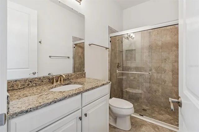 a spacious bedroom with a bed and a walk in closet