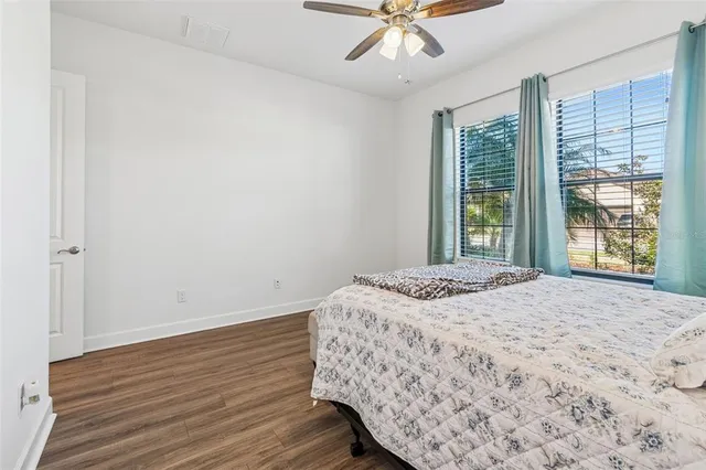 a spacious bathroom with a granite countertop sink mirror and vanity