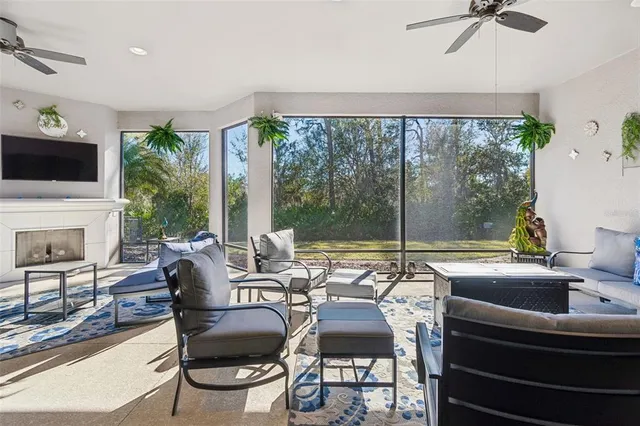a view of a livingroom with furniture and floor to ceiling window