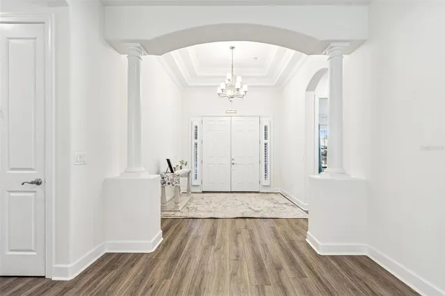 a kitchen with stainless steel appliances a table chairs sink and cabinets