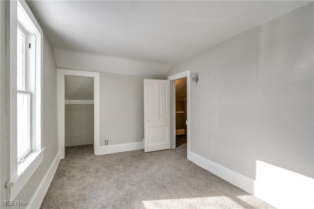 46 Rosenberry Street Alliance, OH 44601 - Photo 25 of 39 Unfurnished bedroom featuring lofted ceiling, a closet, and light colored carpet