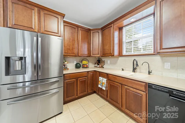 a kitchen with stainless steel appliances granite countertop a refrigerator sink and cabinets