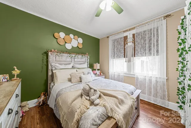 a bed sitting in a bedroom next to a window
