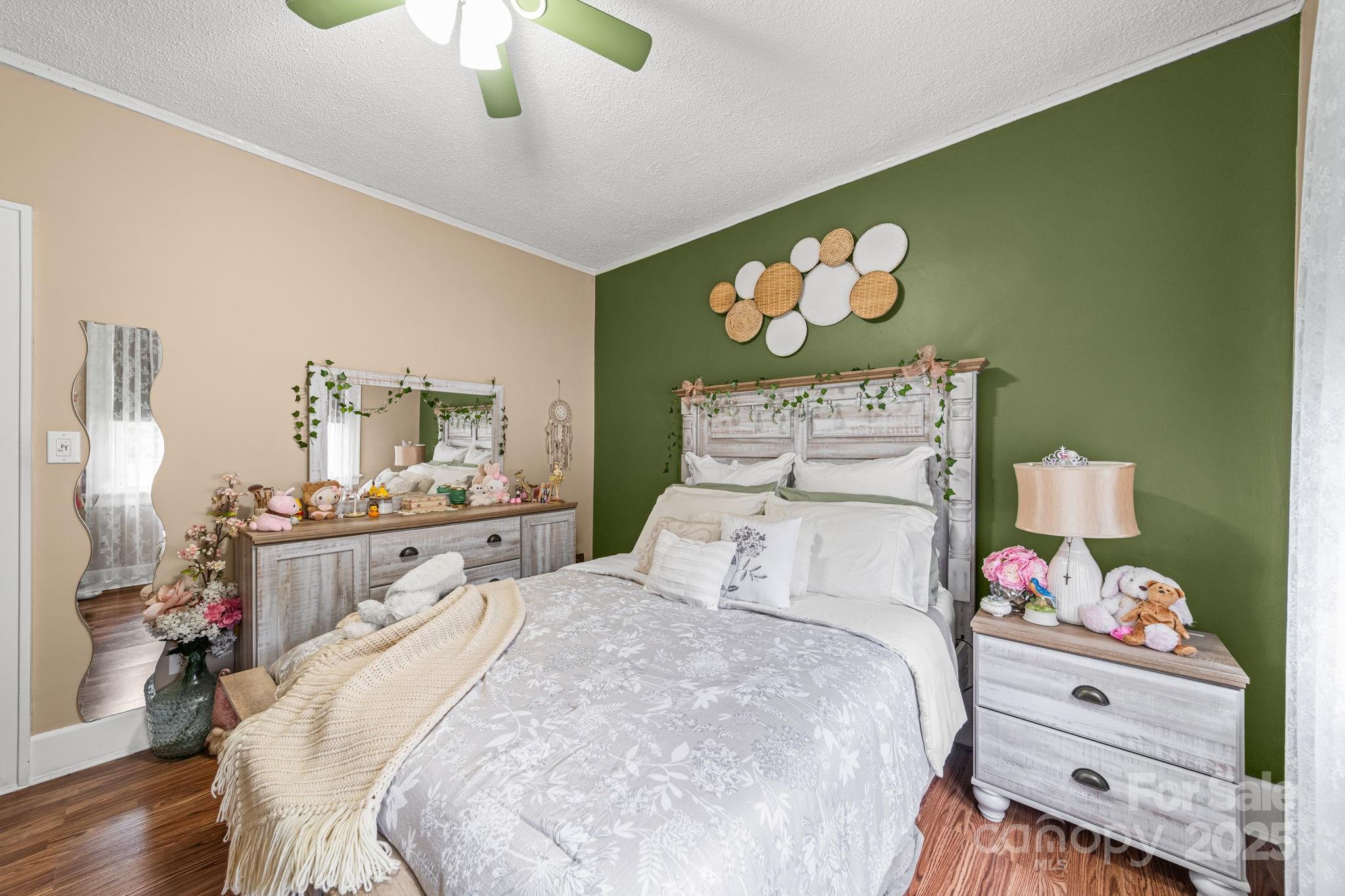 745 Dukeville Road Salisbury, NC 28146 - Photo 23 of 40 a bedroom with a bed and a chandelier