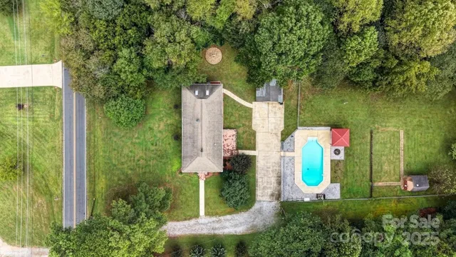 an aerial view of residential house with outdoor space and trees